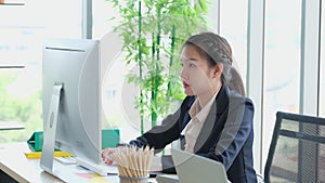 Young Asia women typing keyboard alone in the office in the morning. Business women working on the computer