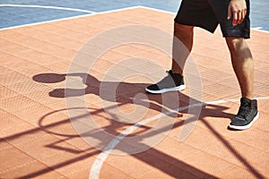 Young asian adult playing basketball