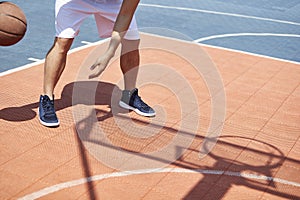 Young asian adult playing basketball