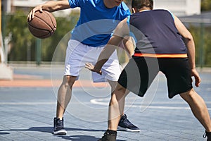 Young asian adults playing basketball