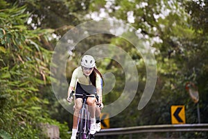 young asian adults riding bike on rural road