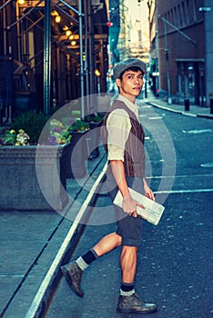 Young Asian American man walking on street in New York City