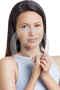 Young Asian American woman with injjured finger on white background