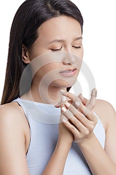 Young Asian American woman with injjured finger on white background