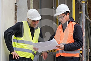 Young Asian apprentice at work with senior engineer