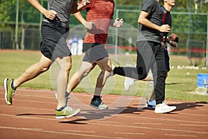 Young asian athletes competing on track