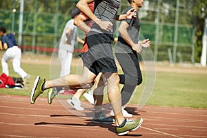 Young asian athletes competing on track