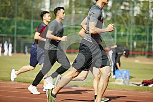 Young asian athletes competing on track