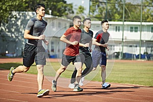 Young asian athletes running on track