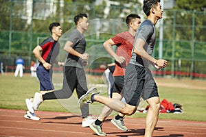 Young asian athletes running on track
