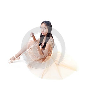 Young Asian Ballerina Tying Her Ballet Pointe Shoes