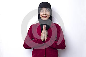 Young asian beautiful muslim woman show welcome gesture isolated on white background