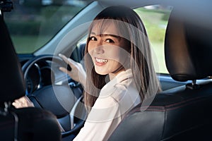 Young asian beautiful woman driving a car with fastened seatbelt