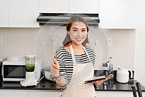 Young asian beautiful woman preparing food in kitchen at home