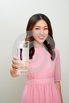 Young asian beautiful woman showing the glass of water.