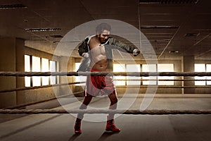 Young asian boxer man workout punching