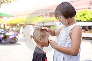 Young asian boy crying and his old sister try to encourage