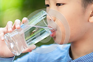 Young Asian boy drink water