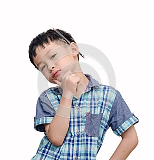 Young Asian boy looks serious with pencil