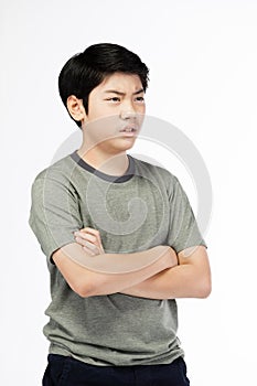 Young Asian boy over white background, be upset; have a bad temper emotional