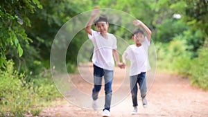Young Asian boy run and wave