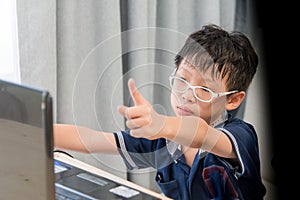 Young Asian boy using laptop