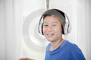 Young Asian boy using laptop technology at home. copyspace