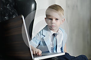 Young Asian boy using laptop technology at home.