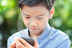 Young Asian boy using mobile phone