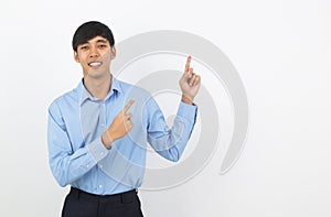 Young asian business man with blue shirt pointing to the side with a hand to present a product or an idea isolated on white
