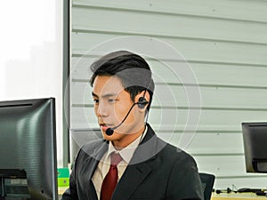 The young Asian business man is a customer service call center worker in business financial office