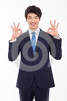 Young Asian business man showing okay sign.