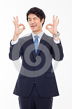 Young Asian business man showing okay sign.