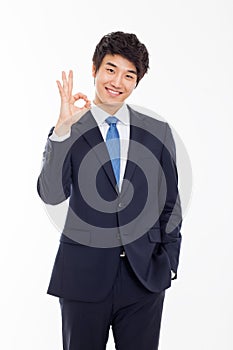 Young Asian business man showing okay sign.