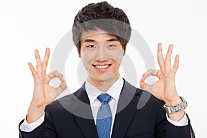 Young Asian business man showing okay sign