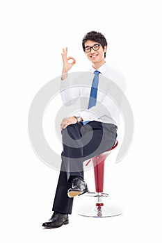 Young Asian business man showing okay sign.