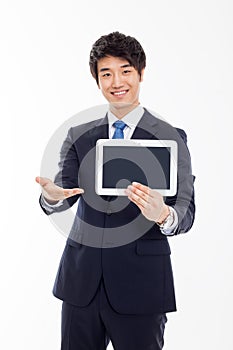 Young Asian business man showing a pad PC