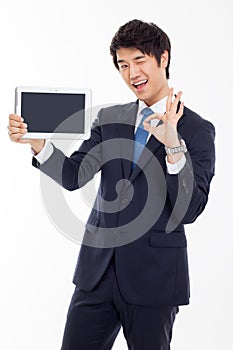 Young Asian business man showing a pad PC