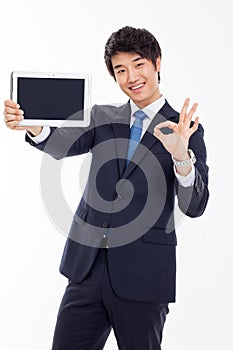 Young Asian business man showing a pad PC