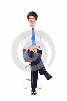 Young Asian business man sitting on the chair. photo