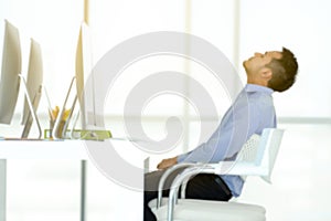 Young Asian business man sitting by the desk is work and rest on