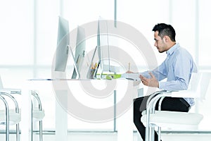 Young Asian business man sitting by the desk is work and rest on