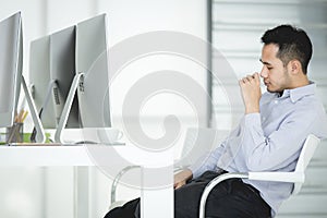 Young Asian business man sitting by the desk is work and rest on