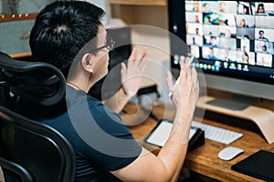 Young asian business man using computer for a online business meeting with his colleagues about plan in video conference. back