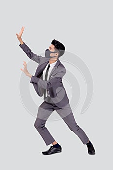 Young asian business man wearing face mask pushing something isolated on white background.