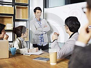 Young asian business person facilitating a discussion photo