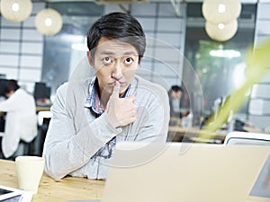 Young asian business person thinking hard in office