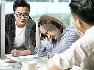 Young asian business woman appearing to be frustrated during a discussion in office