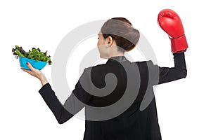 Young Asian business woman with boxing glove and salad