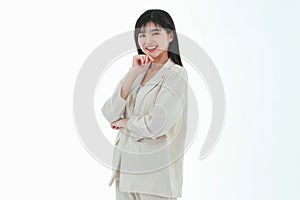 A young asian business woman has a big smile and place a finger close to her cheek, looking up to the side on copy space white